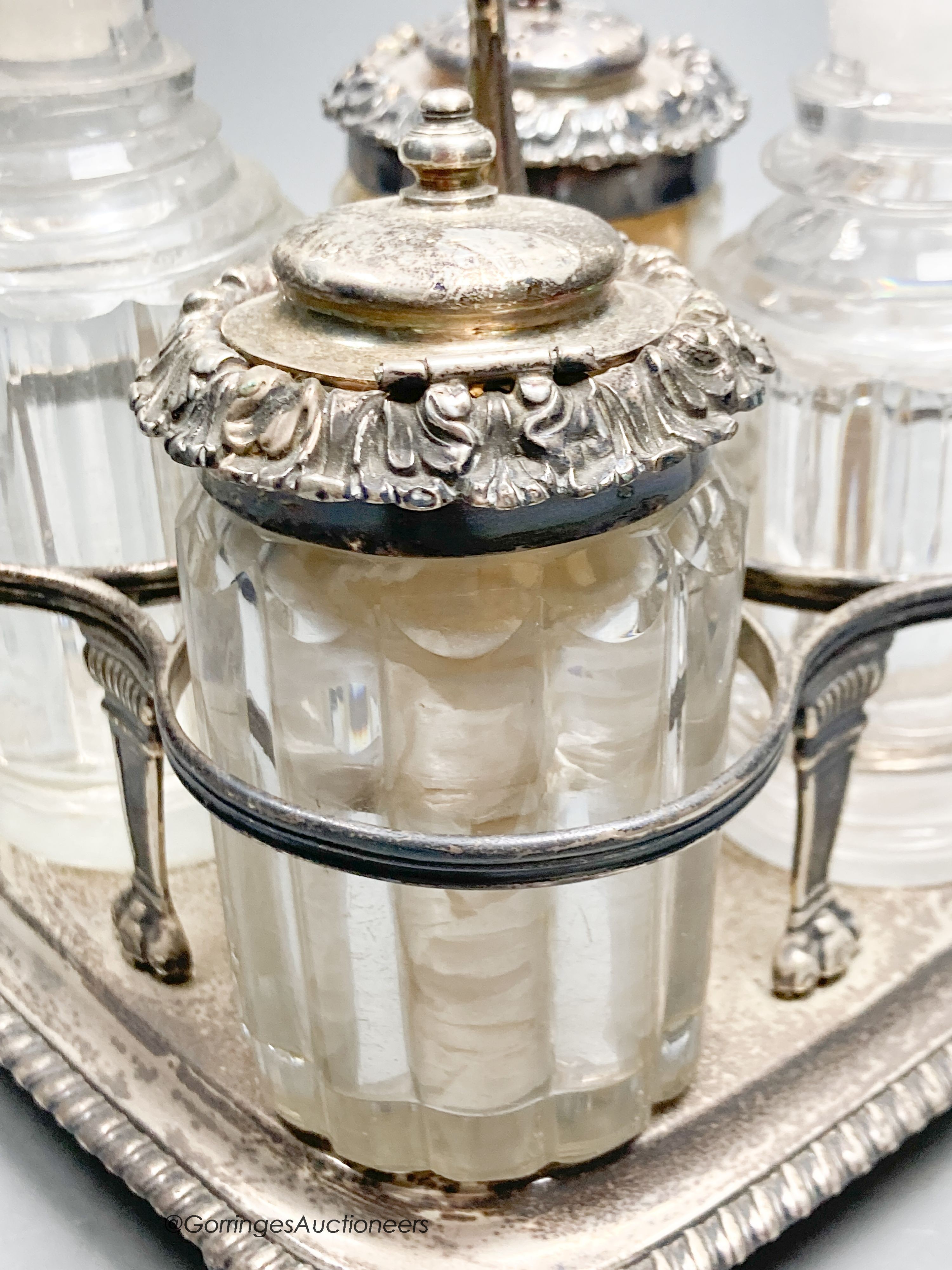 A George III silver cruet stand, by Emes & Barnard, London, 1813 and four associated cruets, two with silver mounts, 21.5cm, 13.5oz.